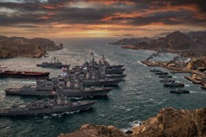 Naval fleet anchored near coastline.